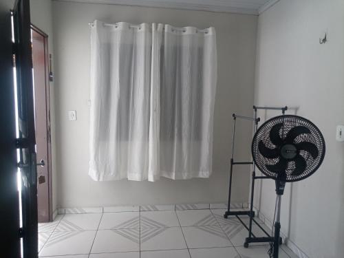 a white room with a fan and a window at Pousada Recanto do Mar in Tutóia