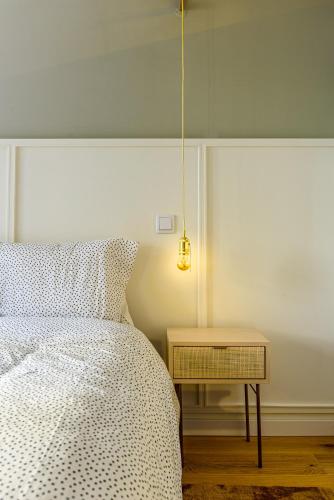 a bedroom with a bed and a side table at Charming Studio in central Lisbon in Lisbon