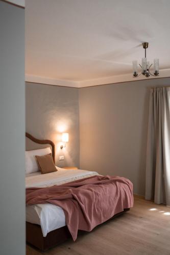 a bedroom with a large bed in a room at Leuchtenburg am See in Caldaro