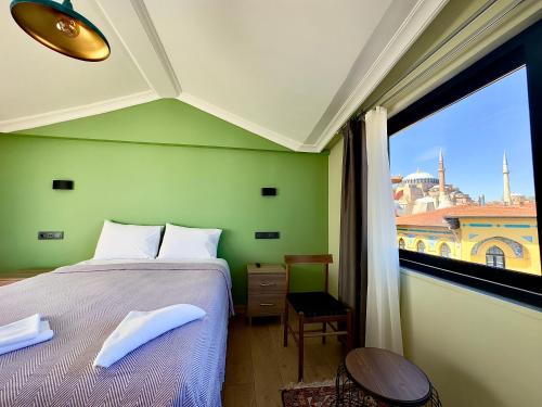 a bedroom with a bed and a large window at Terrace Guesthouse in Istanbul