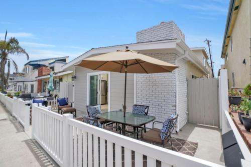 a patio with a table and an umbrella at 114 Forty-Second Street A in Newport Beach