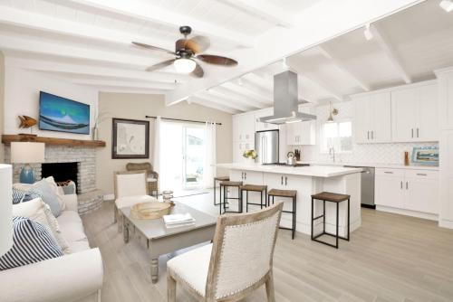 a kitchen and living room with a table and chairs at 114 Forty-Second Street A in Newport Beach