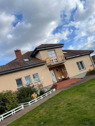 a large house with a white fence in front of it at Kopice " Kowalczyk In Nature Parks Blue Velo" in Gollnow