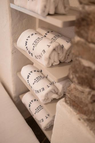 a bunch of towels are stacked on a shelf at Leuchtenburg am See in Caldaro