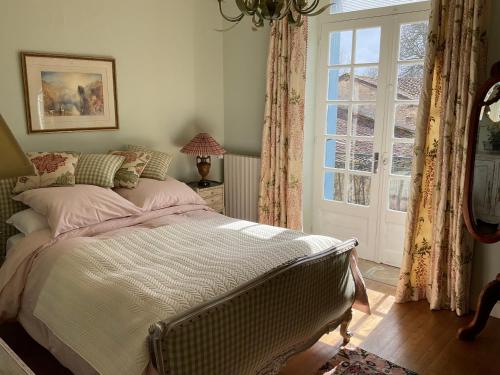 a bedroom with a large bed and a window at 'Mulberry House' - A Darling Abode Nr Brantome in La Tour-Blanche