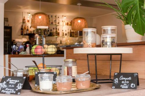 a counter with two trays of drinks in jars at The Originals City, le Beaujoire, Nantes - FACE Parc Expo et FACE Stade Beaujoire in Nantes