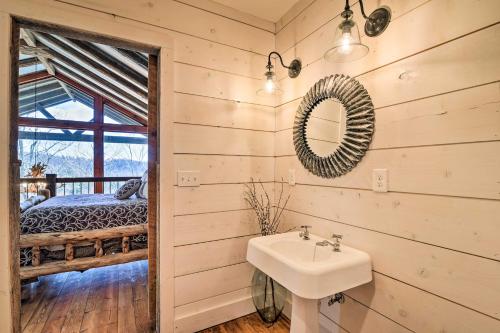 a bathroom with a sink and a bedroom at Lakefront Lewisburg Vacation Rental with Deck! in Lewisburg