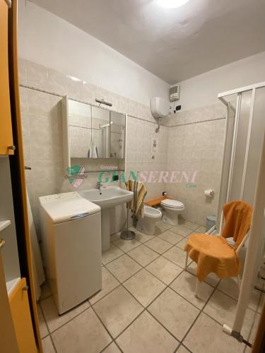 a bathroom with a sink and a toilet and a mirror at CorsoItalia43c in San Vincenzo