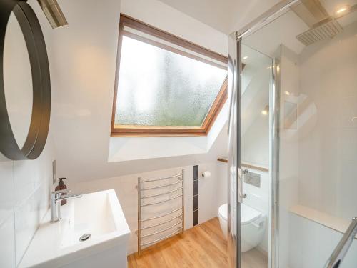 a bathroom with a sink and a window at The Loft in Yealmpton
