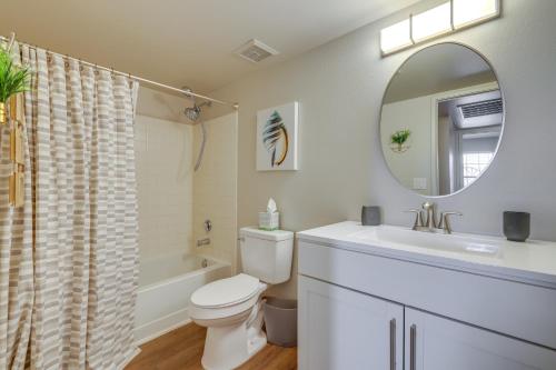 a bathroom with a toilet and a sink and a mirror at Pet-Friendly Phoenix Vacation Rental Pool Access! in Phoenix