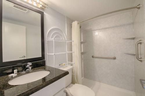 a bathroom with a sink and a shower and a toilet at 209 Little Harbor Inn in Ruskin