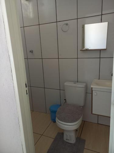 a small bathroom with a toilet and a mirror at HELLO MT POUSADA in Nobres