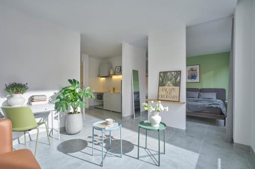 a kitchen and living room with a table and chairs at M Village Living Cửu Long in Ho Chi Minh City