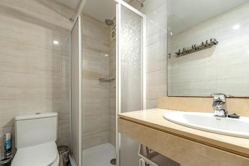 a bathroom with a toilet and a sink and a shower at Ocean view Family Apartment in Playa La Arena in Puerto de Santiago