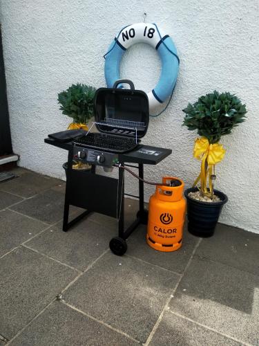 a table with a grill and a no sign on a wall at Fishermans Cottage in Killough