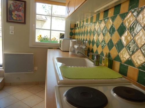 a kitchen with a sink and a counter top at Calme et verdure en plein coeur d Illiers Combray in Illiers