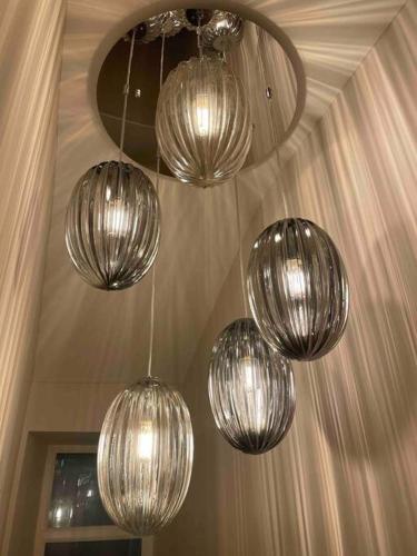 four silver chandeliers hanging from a ceiling at Heather Mere Cottage, Bowness-on-Windermere in Bowness-on-Windermere