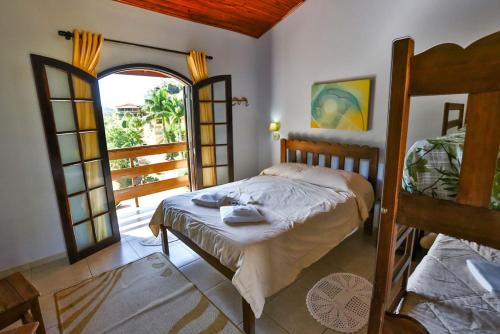a bedroom with two bunk beds and a balcony at Hotel Fazenda Village Montana in Socorro