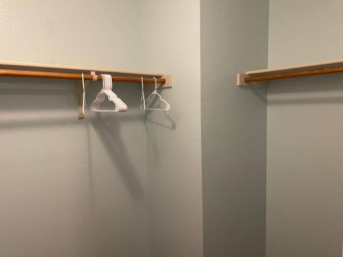 a bathroom with two white hangers on a wall at Room Downtown Dallas in Dallas