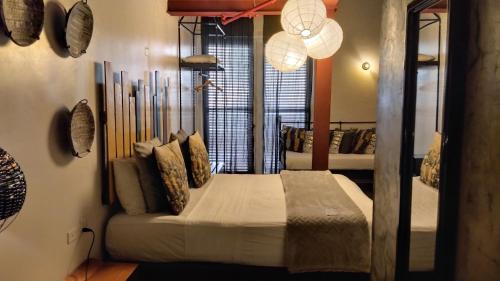 a bedroom with a bed in a room with a mirror at Hotel Casa Panama in Panama City