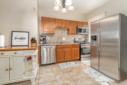 a kitchen with wooden cabinets and stainless steel appliances at 3 or 4 Bdrm Home Near Univ of Cincinnati in Cincinnati