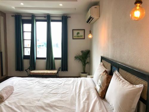 a bedroom with a white bed with a window at Avatar Living@ Greater Kailash 2 in New Delhi
