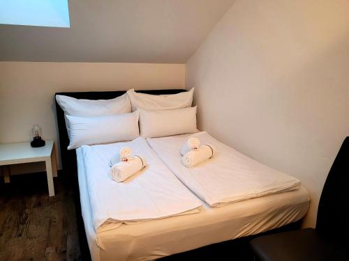 a bed with two hello kitty towels on it at Ferienwohnung Lindpointner in Innerschwand am Mondsee