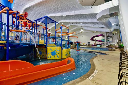 a large indoor water park with a water slide at 7Clans Hotel & Resort in Newkirk