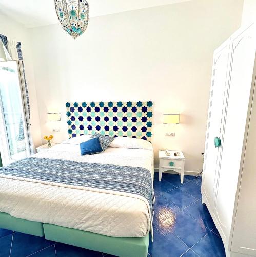 a bedroom with a bed with a blue floor at Hotel Villa Delle Palme in Positano in Positano