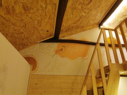 a staircase in a house with a painting on the wall at Linda House in Casais de São Mamede
