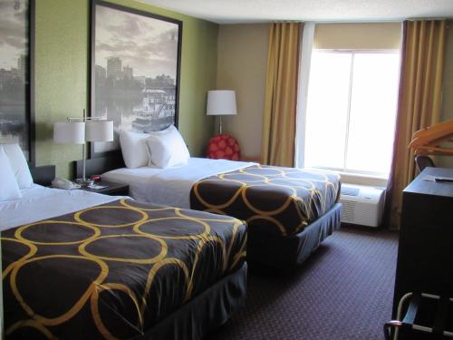 a hotel room with two beds and a window at Super 8 by Wyndham New Cumberland in New Cumberland