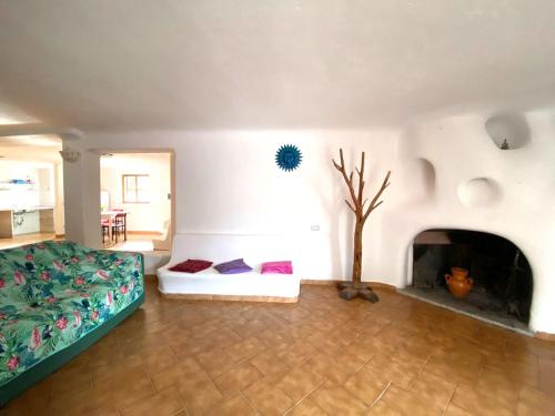 a living room with a bed and a fireplace at Appartamento Orticello in Cala Gonone