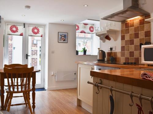 a kitchen with a table and a counter top at The Briar in Idridgehay