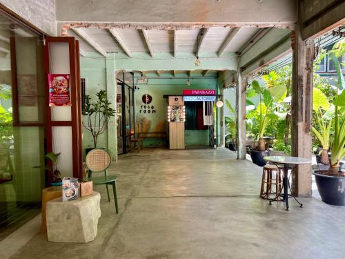 a corridor of a building with a table and chairs at GalileOasis Boutique Hotel in Bangkok