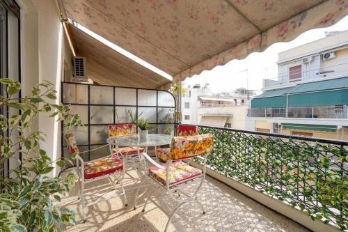 a patio with a table and chairs on a balcony at Classy & Comfy 1 BD Apt 4' to Acropolis in Athens
