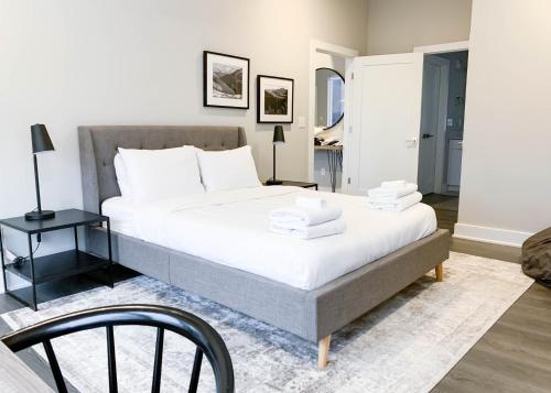 a bedroom with a large bed with white sheets at Mason Lofts at West End in Nashville