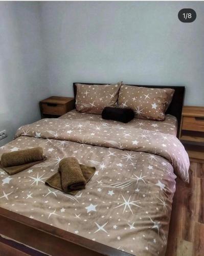 a bedroom with a bed with white snowflakes on it at Kod Popaja in Bajina Bašta