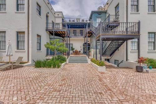 a brick driveway in front of a building with a staircase at Bellwether House in Savannah