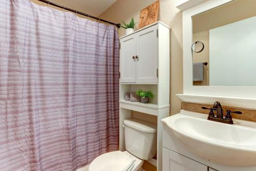 a bathroom with a white toilet and a sink at Cascade Comfort in Redmond