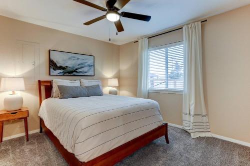 a bedroom with a bed and a ceiling fan at Cascade Comfort in Redmond