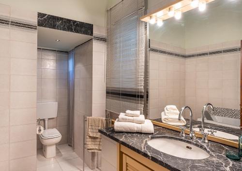 a bathroom with a sink and a toilet and a mirror at Ludyta House in centro Arezzo in Arezzo