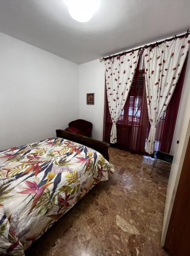 a bedroom with a bed and a window at Appartamento Nonna Carmela in Pescara