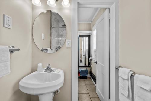 a bathroom with a sink and a mirror at Dolphin Oceanfront Motel - Nags Head in Nags Head