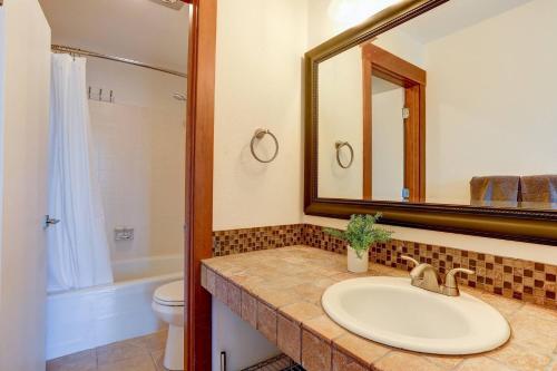 a bathroom with a sink and a mirror and a toilet at 7th Mountain Bliss in Bend