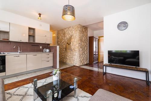 a large living room with a kitchen and a table at IL MURO apartment in Zadar