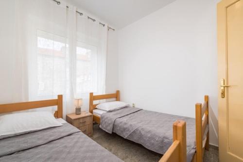 a bedroom with two beds and a window at IL MURO apartment in Zadar