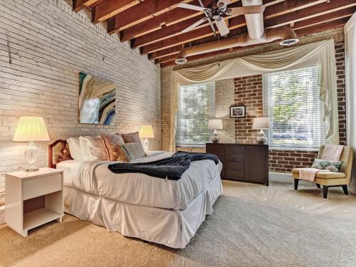 a bedroom with a large bed and a brick wall at Riverview Terrace in Savannah