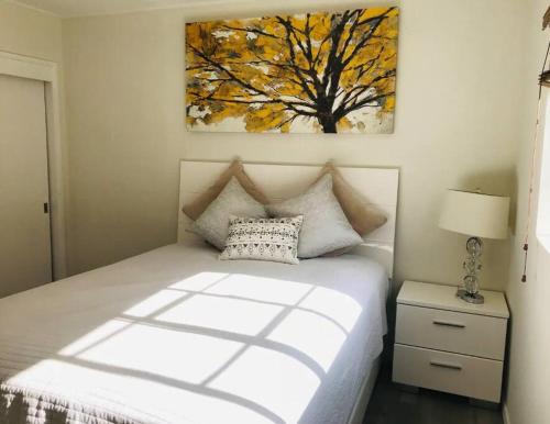 a bedroom with a bed and a painting on the wall at 2 Bd Beverly Hills Guest House in Los Angeles