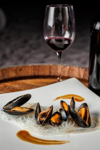 a plate of mussels next to a glass of wine at Resort at Longboat Key Club in Sarasota