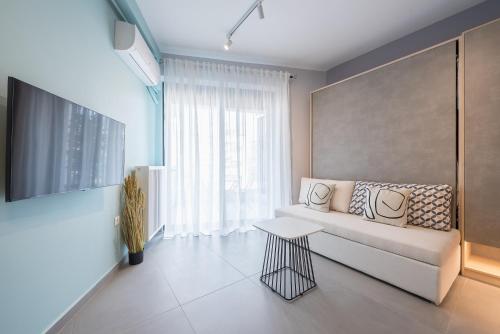 a living room with a couch and a table at Stylish Urban Suites in Athens
